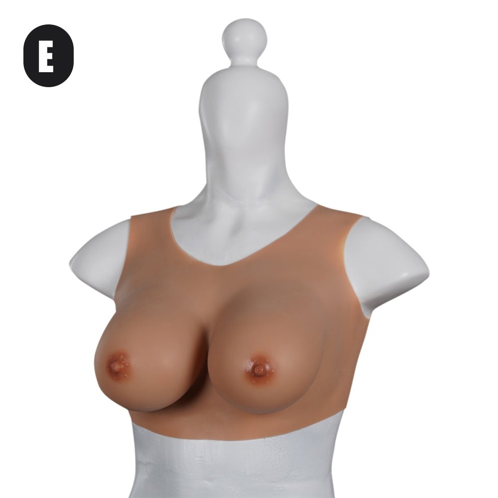 Naked woman with small breasts holding silicon breast form